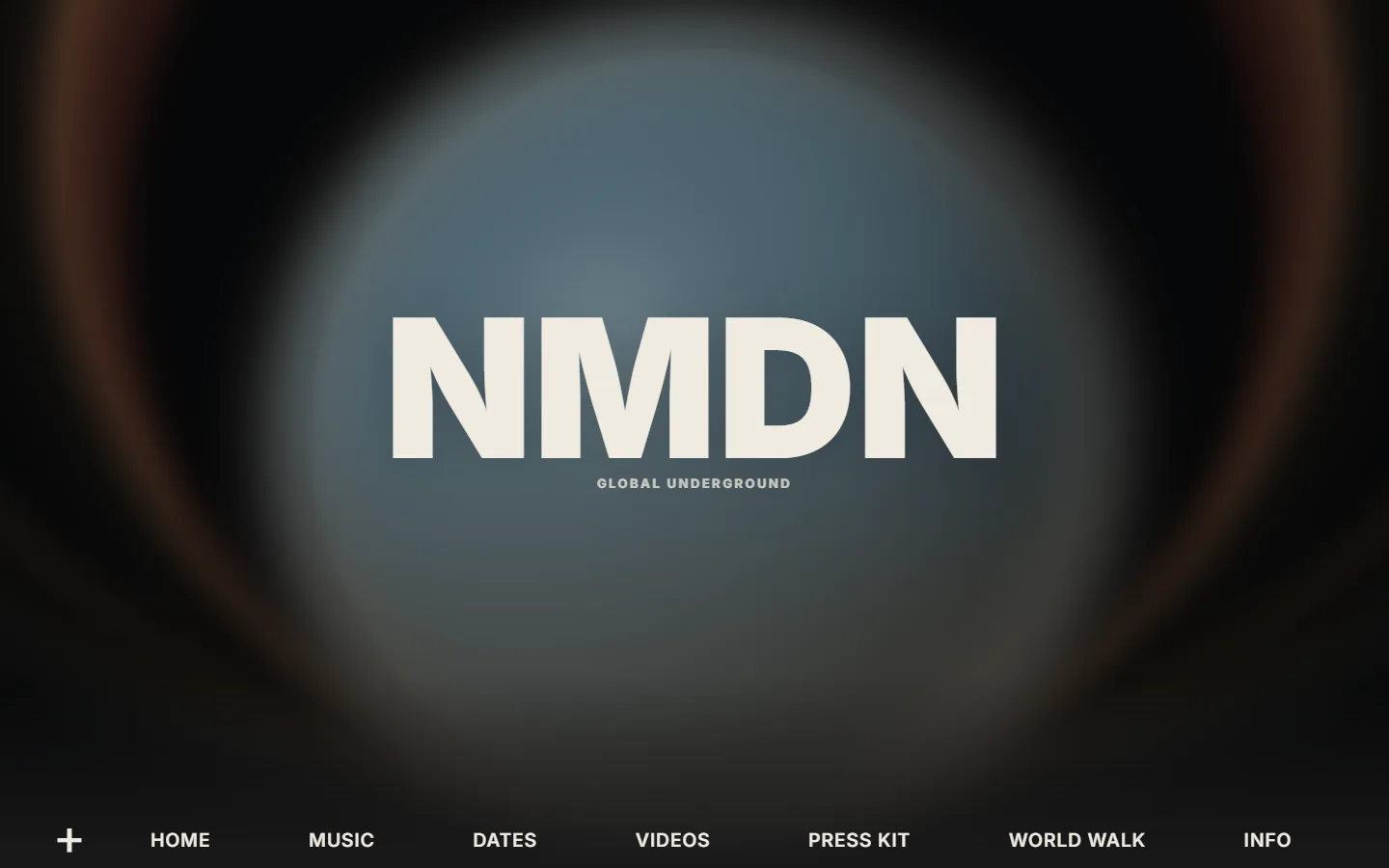 NMDN website hero with wordmark over orb visual